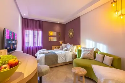 a hotel room with a bed and a couch at Central 1BR Studio- AC & IpTV-Self check in- 2 guests in Marrakech