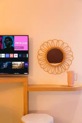 a mirror on a wall next to a table with a chair at Central 1BR Studio- AC & IpTV-Self check in- 2 guests in Marrakech