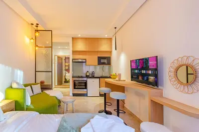 a living room and a kitchen with a couch and a table at Central 1BR Studio- AC & IpTV-Self check in- 2 guests in Marrakech