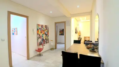 a dining room and living room with a table and chairs at דירה