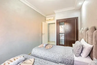 a bedroom with two beds and a mirror at Dreamy Home Climatisation and design in Oulad Akkou