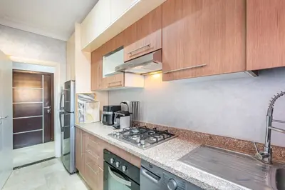 a kitchen with wooden cabinets and a counter top at Dreamy Home Climatisation and design in Oulad Akkou