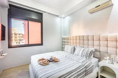 a small bedroom with a bed and a window at Dreamy Home Climatisation and design in Oulad Akkou
