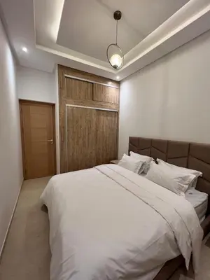 a bedroom with a large white bed with a light at Luxury apartment - Quiet and family-friendly neighborhood in Marrakech