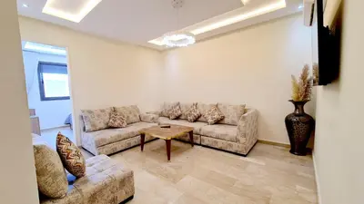 a living room with two couches and a table at דירת