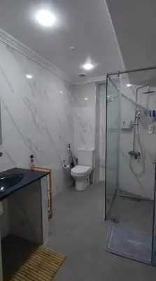a bathroom with a shower and a toilet and a sink at Beautiful Bright Apartment Victor Hugo District in Marrakech