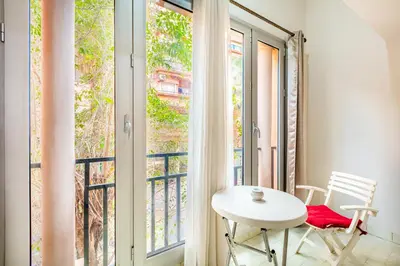 a balcony with a white table and a window at Cozy Nest balcony and bright in Marrakech