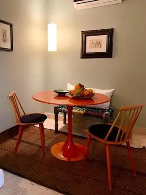 a table with two chairs and a bowl of fruit on it at Riad Dar Bou Seta - Small Riad in Marrakech