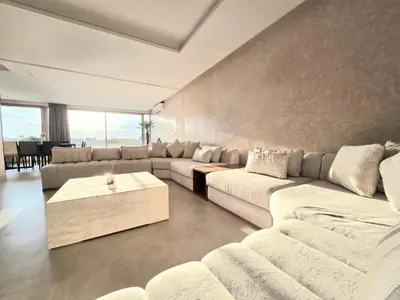 a large living room with couches and a table at Penthouse Prestigia Village Panoramique sur le Lac in Marrakech