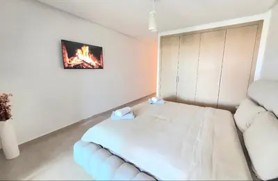 a small bedroom with a bed and a couch at Penthouse Prestigia Village Panoramique sur le Lac in Marrakech
