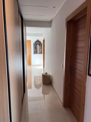 a hallway of a house with a door and a table at Azzizi in Marrakech