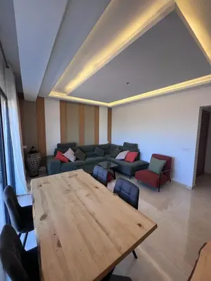 a living room with a wooden table and a couch at Azzizi in Marrakech