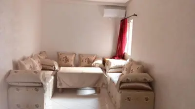 a living room with a couch and a window at appartamento lalla Rita short-term rent in Marrakech