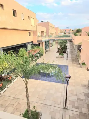 a view of the courtyard of a building with a pool at Penthouse Marrakech Village avec vue Panoramique sur le Lac in Marrakech