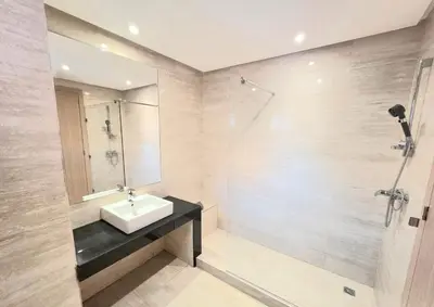 a bathroom with a sink and a shower at Penthouse Marrakech Village avec vue Panoramique sur le Lac in Marrakech