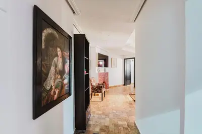 a hallway with a painting on the wall and a couch at Cocon au calme Residence Piscine Marrakech in Marrakech