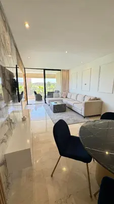 a living room with a couch and a table at Magnifique appartement in Marrakech