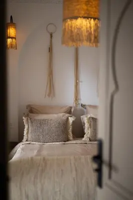 a bedroom with a bed with two lamps on the wall at Riad Kasbah Lover Swimming pool breakfast included in Marrakech
