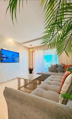 a living room with a couch and a table at Modern 3BR Luxury Prestigia Golf in Marrakech