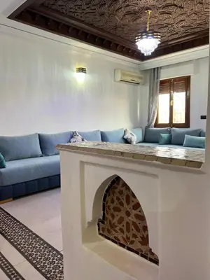 a living room with a couch and a fireplace at Stylish 2-Bedroom City Apartment in the city of Marrakech in Marrakech