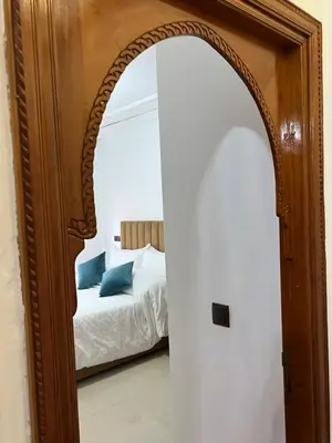 an archway leading into a bedroom with a bed at Stylish 2-Bedroom City Apartment in the city of Marrakech in Marrakech