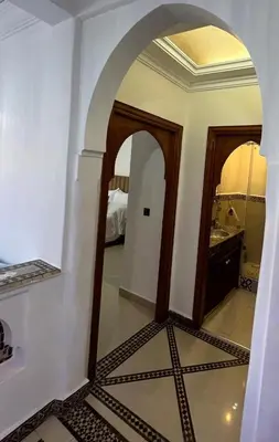 an arched doorway into a room with a bedroom at Stylish 2-Bedroom City Apartment in the city of Marrakech in Marrakech