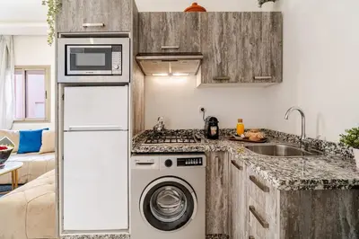 a kitchen with a washing machine and a sink at Charming Studio Center, Quiet, Well Placed in Marrakech