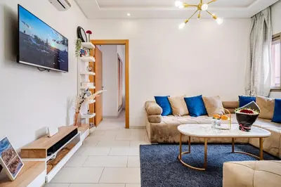 a living room with a couch and a table at Charming Studio Center, Quiet, Well Placed in Marrakech