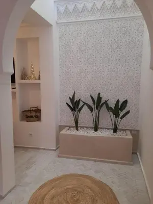 a room with two potted plants on a wall at Riad Douiria MiLa Luxury Private 2 to 4 people in Marrakech
