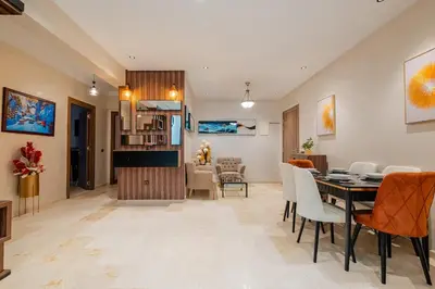 a dining room and living room with a table and chairs at Central Luxury Gem marrakech 3BR in Marrakech