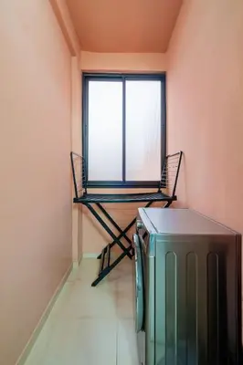 a room with a window and a tv and a chair at Central Luxury Gem marrakech 3BR in Marrakech