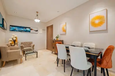 a dining room with a table and chairs at Central Luxury Gem marrakech 3BR in Marrakech