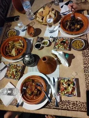 a table with plates of food on it at Riad Palm Oasis Marrakech in Marrakech