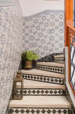 a set of stairs with a tile wall at Riad Palm Oasis Marrakech in Marrakech
