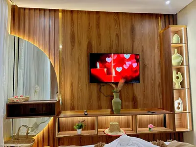 a living room with a tv on a wooden wall at Central Victor Hugo Studio near Gueliz Wi-Fi in Marrakech