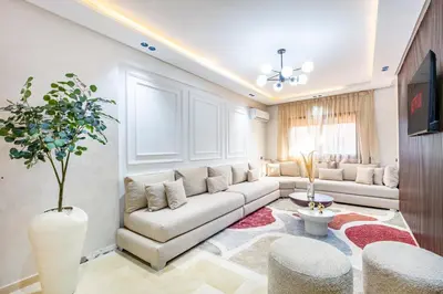 a living room with a couch and a table at Appartement Élégant Quartier Hivernage in Marrakech