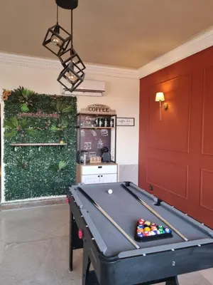 a ping pong table in a room with a wall at BOHO Marrakech Medina in Marrakech