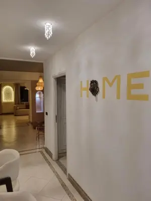 a living room with a me sign on a wall at BOHO Marrakech Medina in Marrakech