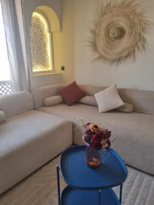 a living room with a couch and a blue table at BOHO Marrakech Medina in Marrakech