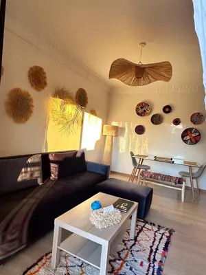 a living room with a couch and a table at Serenity Loft in Marrakech