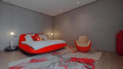 a bedroom with a red bed and a red chair at Villa Marrakech, Piscine Privée, Sauna et Gym in Marrakech