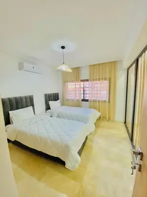 a large bedroom with two beds in it at duplex 3 Rom with spacious Guéliz victor hugo spacieuse in Marrakech