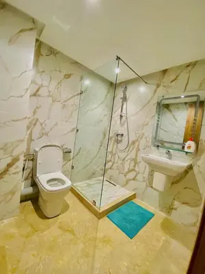 a bathroom with a shower and a toilet and a sink at duplex 3 Rom with spacious Guéliz victor hugo spacieuse in Marrakech