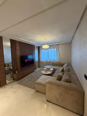 a living room with a couch and a television at Séjour Premium - Piscine, Jacuzzi, Chauffé et Salle de sport in Marrakech