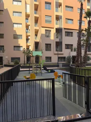 a playground in front of a apartment building at Séjour Premium - Piscine, Jacuzzi, Chauffé et Salle de sport in Marrakech
