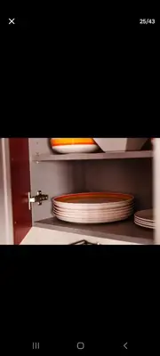a stack of plates sitting on a shelf at Appartemment Luxe Gueliz in Marrakech