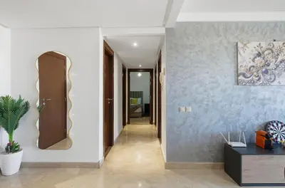 a hallway with white walls and a mirror on a wall at Modern apartment, swimming pool and sports in Marrakech