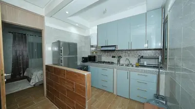 a kitchen with a sink and a refrigerator at Little dream in Marrakech