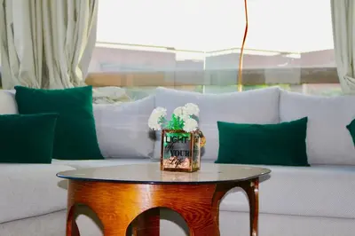 a living room with a white couch and a table at Red nelbrj appartement in Marrakech