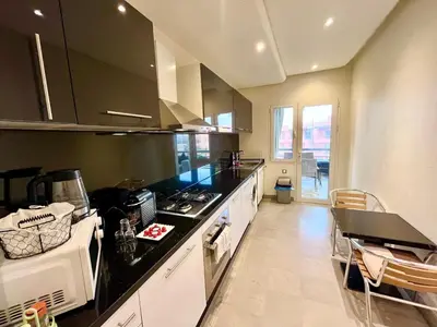 a kitchen with a stove and a counter top at Red nelbrj appartement in Marrakech